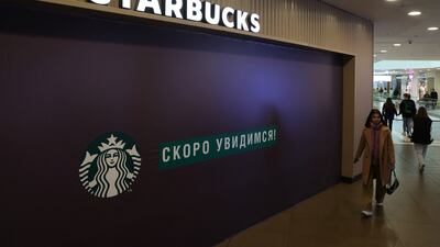 A woman walks past a closed Starbucks cafe in central St Petersburg, Russia, on May 23, 2022. Reuters