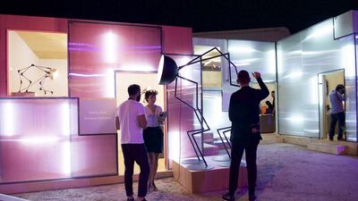 Visitors observe an art installation at the converted warehouse in Mina Zayed. Vidhyaa for the National