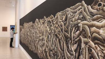 Indian artist Abdulla P A’s 10-metre-long oil painting at Rizq Art Initiative on Reem Island. Antonie Robertson / The National