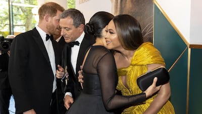 Prince Harry chats with Disney CEO Robert Iger as Meghan, Duchess of Sussex embraces Beyonce as they attend the premiere of Disney's 'The Lion King' in London's Leicester Square on July 14, 2019. AFP