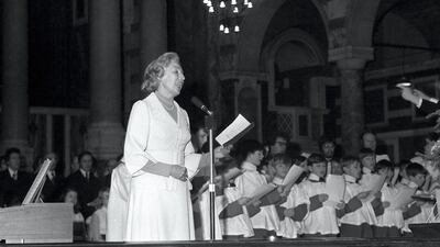 Dame Vera Lynn, accompanied by choirboys, at Westminster Abbey when she took part in the Evening News Festival of Carols.