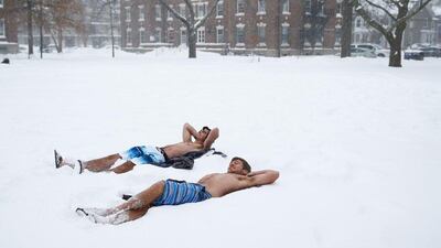 Students lay out in their bathing suits on the Quad, on the campus of Harvard University on January 27, 2015 as Boston, and much of the Northeast, was hit with heavy snow from Winter Storm Juno. Maddie Meyer/Getty Images/AFP