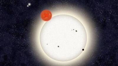 An illustration of PH1, a planet discovered by volunteers from the Planet Hunters citizen science project. PH1 is orbiting two suns, and in turn is orbited by a second distant pair of stars.