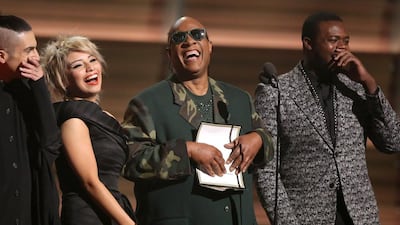 Stevie Wonder, centre, and from left Mitch Grassing, Kristin Maldonado, and Kevin Olusola of Pentatonix present the award for song of the year at the 58th annual Grammy Awards. Matt Sayles / Invision / AP