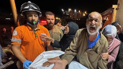 Palestinians with the body of a man killed by an Israeli strike in Khan Younis on Tuesday. Reuters