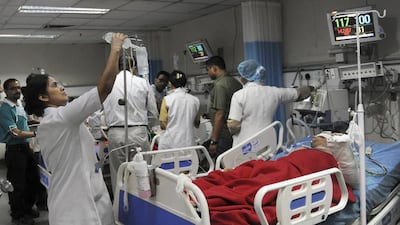 Indian nurses tend to patients at a government hospital in New Delhi. The country's public health system is under strain as there is a severe shortage of medical doctors. Ravendran/AFP Photo