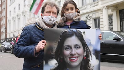 Richard Ratcliffe, the husband of Nazanin Zaghari-Ratcliffe, with his daughter Gabriella pose for photographers during a protest outside the Iranian Embassy in London. EPA