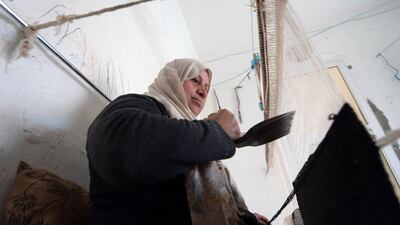 Najet works in the southwestern Tunisian oasis of Nefta, at a workshop run by Shanti, a social enterprise that helps artisans from across the North African country, in the capital Tunis, on February 12, 2022. - The women who work for Shanti use an eclectic array of old pullovers, socks and assorted pass-me-downs from the local flea market, giving them a new life as rugs. The project fills a valuable niche in an area where women are disproportionately underemployed, and which has faced an ever-worsening economic crisis since before the revolt that sparked the Arab Spring uprisings of 2011. (Photo by FETHI BELAID / AFP)