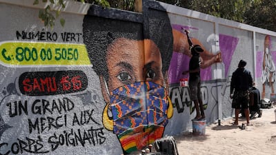 Graffiti artists from RBS crew work on their mural to encourage people to protect themselves amid the outbreak of the coronavirus disease in Dakar, Senegal. Reuters