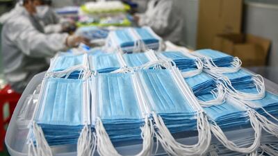 Workers producing face masks. AFP