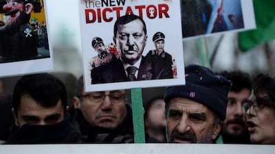 A protester holds a banner depicting Turkish President Erdogan during a demonstration against a visit of the president in Brussels. Reuters