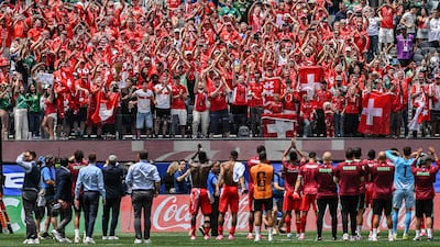 Swiss fans celebrate with the players after winning against Bosnia and Herzegovina in Los Angeles. AFP