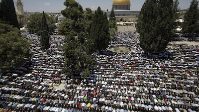Palestinian worshippers pray in front of the Al-Aqsa Mosque in Jerusalem during the first Friday of the holy month of Ramadan. The golden Dome of the Rock shrine is seen in the background. Mahmoud Illean / AP photo
