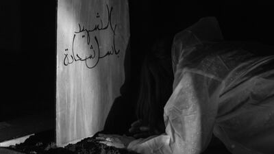 An audience member uncovering a grave in ‘Gardens Speak’ Waleed Shah