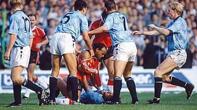 Manchester United’s Danny Wallace grabs Manchester City’s Andy Hinchcliffe around the throat as City players rush to intervene during a match at Maine Road in the 1989/90 season. City won the match 5-1, but it is United who have claimed local bragging rights in the Premier League era.