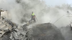 Civil defence members battle fire at the site an Israeli air strike that targeted a building in the southern Lebanese village of Ain Qana earlier this month. AFP