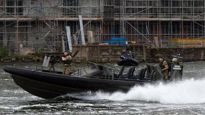 Military personnel aboard a Royal naval vessel perform maneouvres during the Defence and Security Exhibition. Ben Pruchnie / Getty Images