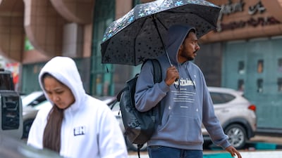 Umbrellas to the rescue. Victor Besa / The National