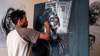 Eritrean artist Nebay Abraha, 23, paints in his room and studio in Addis Ababa on December 6, 2019. AFP