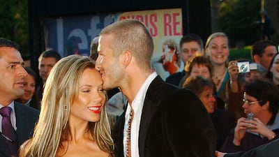 David, in jeans, beads and a bandana 'kerchief, and Victoria Beckham arrive at 19 Management's 19th anniversary party at the Royal Albert Hall on April 19, 2004 in London, England. Getty Images