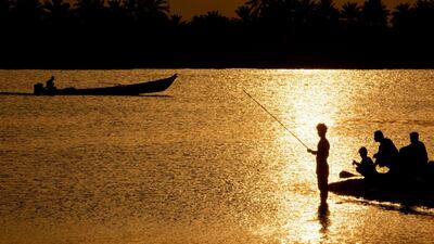 Iraqis fish at the Shatt Al Arab river, formed by the confluence of the Euphrates and the Tigris, near Basra in southern Iraq. AFP