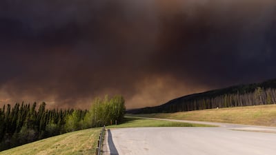 Wildfire smoke near Trutch, British Columbia, Canada, on Friday. Wildfires are threatening about 5% of Canada's crude output as a blaze in Alberta's oil sands region spreads and approaches major production sites. Bloomberg