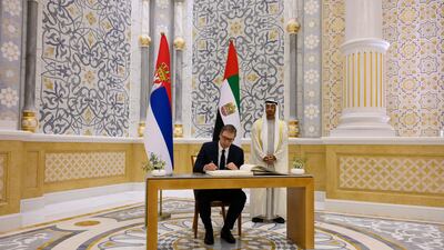 Mr Vucic signs the visitors book.