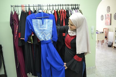 Mai Hammad embroiders new dresses out of old garments. Photo by Naomi Zeveloff