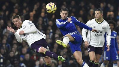 Eden Hazrd, centre, of Chelsea shoots past James MacCarthy of Everton during their English Premier League soccer match at Stamford Bridge, London, February 11, 2015. REUTERS/Toby Melville