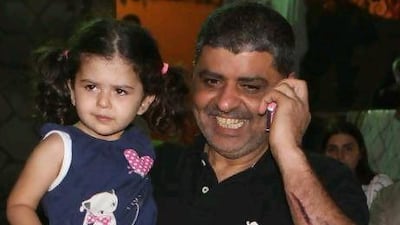 Kuwaiti hostage Issam Al Houti carries daughter Hana after being released in Baalbek in the Bekaa Valley.