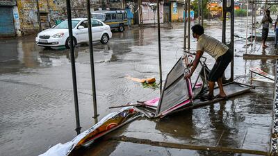 A shopkeeper begins to clear up after cyclone Tauktae hit the city of Amreli, Gujurat state, western India. AFP