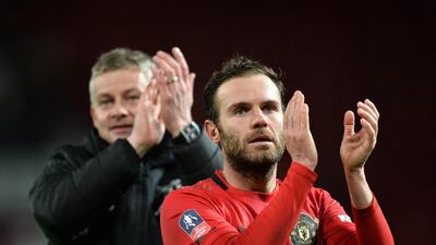 Manchester United manager Ole Gunnar Solskjaer and midfielder Juan Mata applaud fans at the end of the game. EPA