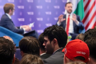 A member of the audience wears a cup in support of US President Donald Trump as US Vice President JD Vance delivers remarks at Mathias Corvinus Collegium in Budapest. Getty Images