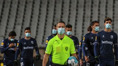 Belenenses' players arrive at the pitch before the match. AFP