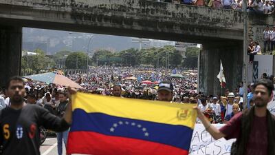 Anti-government protesters block a road in Caracas, Venezuela. Fernando Llano / AP Photo