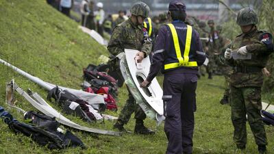 A rescue crew carries a window from a TransAsia Airways ATR 72-600. Ashley Pon / Getty Images