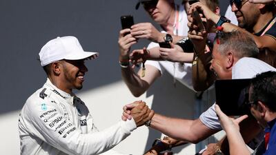 Mercedes driver Lewis Hamilton celebrates with fans after his win. Tony Gutierrez / AP Photo