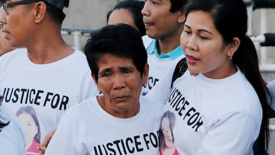 Family members wait for the arrival of the body of Joanna Demafelis, a Filipina domestic helper who was killed and found inside a freezer in Kuwait, in her hometown in Iloilo province in the Philippines last month. Erik de Castro / Reuters