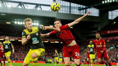 Southampton's James Ward-Prowse, left, vies for the ball with Liverpool's Andy Robertson. EPA