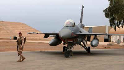 An Iraqi army soldier stands guard near a US-made Iraqi Air Force F-16 fighter jet at Balad airbase. AP