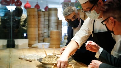 Mayor of London Sadiq Khan, third right, with head chef Ling Bing during a visit to Dumplings Legend in Chinatown, central London. AP Photo