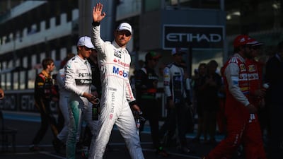 Jenson Button acknowledges the crowd during the drivers' parade. Clive Rose / Getty Images