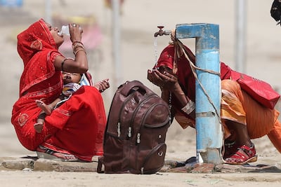 Women quench their thirst during heatwave in Prayagraj, India. South Asia is among regions predicted to exceed global warming targets. AFP
