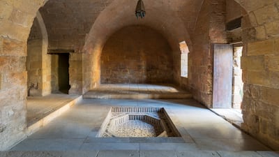 A hall at the Mamluk-era Prince Taz Palace, featuring a vaulted stone-brick ceiling and a marble fountain. Getty Images
