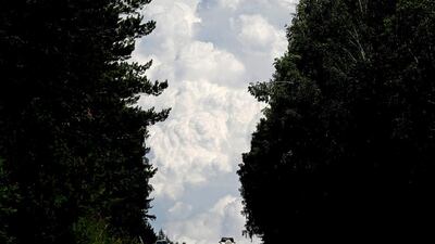 Cars drive along the “Yenisei” M54 federal motorway, with heavy clouds seen in the sky, through the Siberian Taiga area outside Krasnoyarsk, Russia. Reuters