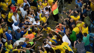 Neymar celebrates the win with fans. Alexandre Loureiro / AFP