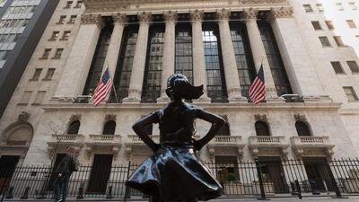 The New York Stock Exchange and the 'Fearless Girl' statue in New York City. Chinese companies are listing in the US at the fastest pace ever, brushing off tensions between the world’s two biggest economies. AFP