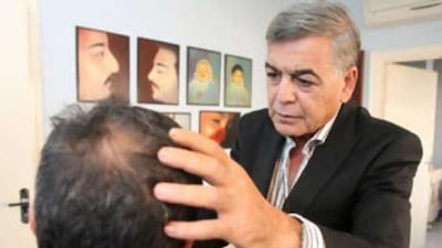 Abdul Salam Abulfailat examines a patient for plastic surgery.