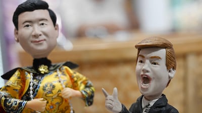 Plastic figures depicting Chinese President Xi Jinping dressed as a Qing Dynasty emperor and US President Donald Trump are displayed for sale in a store in Beijing last Sunday. AFP
