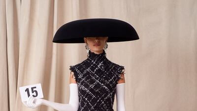 Padded hips and an over-wide brimmed hat by Balenciaga.